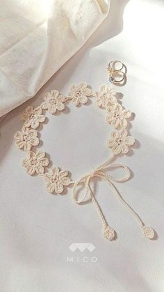 an image of a bracelet and ring on a bed