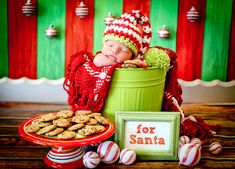 a baby is sleeping in a bucket with cookies