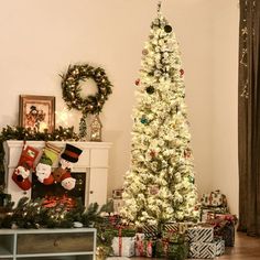 a decorated christmas tree in a living room with presents on the floor next to it