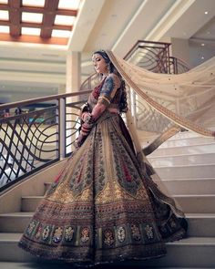 a woman in a wedding dress standing on some stairs