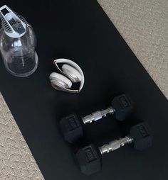 there are two dumbs and one pair of weights on the floor