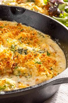 a casserole dish with cheese and broccoli in it on a table