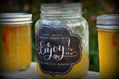 three jars filled with liquid sitting on top of a table