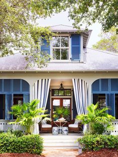 a house with blue shutters and white trim