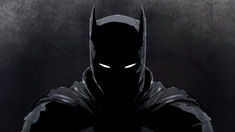 a batman standing in front of a dark background