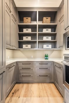 a kitchen with gray cabinets and white counter tops is shown on the appliance