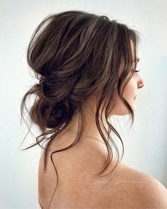 the back of a woman's head with long dark hair and no shirt on