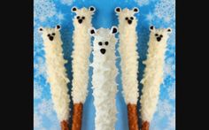 four toothpicks made to look like polar bears are lined up in a row