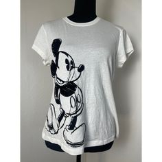 a white shirt with a mickey mouse on it