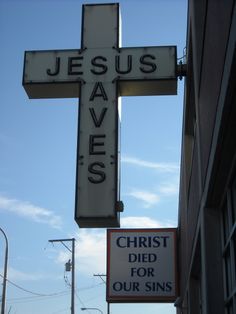 a sign that is on the side of a building saying jesus saves christ died for our sons