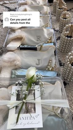 a row of white bags with pearls and flowers in them on the floor next to each other