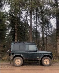 an suv is parked in front of some trees