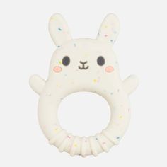 a white bunny shaped ring with sprinkles on it's face and ears