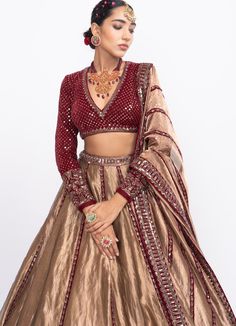 Features a glam tissue lehenga in copper colour teamed with a full sleeved stylish hand embroidered blouse in luxurious velvet. Completed with a copper dupatta with red hues. Composition : Lehenga - Tissue, Dupatta - Tissue, Blouse - Velvet, Lining - Silk Blend Care: Dry Clean Only and Vacuum Storage This product can be customised for sleeves, length of blouse and neckline Delivery : 4-6 weeks as the product is hand crafted. For more information and sizes please contact fabiliciousfashion@gmail. Tissue Chaniya Choli Design, Tissue Lehenga, Lengha Blouse, Telugu Culture, Tissue Dupatta, Hand Embroidered Blouse, Full Sleeve Blouse