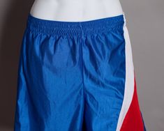 Red, white, and blue gym shorts. Perfect for some sports and leisure time. TEAMWORK Athletic Apparel size - M (32-34) vintage pre-owned Short Bottoms For Cheerleading Sports Season, Short Bottoms For Cheerleading During Sports Season, Blue Cheerleading Shorts, Blue Shorts For Cheerleading, Blue Sportswear Shorts For Sports Events, Stretch Blue Shorts For Sports Events, Blue Shorts For Sports Season, Blue Stretch Shorts For Sports Events, Blue Sports Shorts With Elastic Waistband