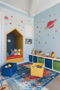 Bright and playful children's playroom featuring a cozy reading nook with colorful cushions, decorative planet-themed wall art, and organized toy storage bins in vibrant colors. Ideal for stimulating creativity and imagination in young children. Play Place