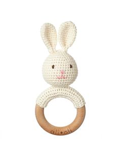 a crocheted bunny ring rattler on a white background with the word hello written across it