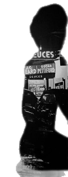 the shadow of a person holding an umbrella in front of a storefront with advertisements on it