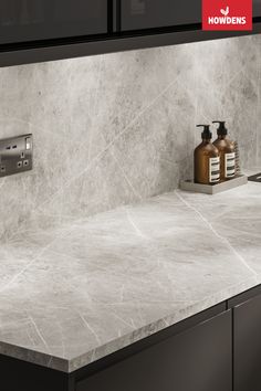 a kitchen counter top with soap dispensers on it