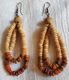 Dangle earrings 3.5 inches long. Faux wood beads. Colors ranging from tan to sienna, with a bit of brown. Excellent condition. For pierced ears. Earthy Brown Earrings With Dangling Beads, Adjustable Brown Beaded Earrings With Large Beads, Brown Large Beaded Dangle Earrings, Brown Large Beads Dangle Earrings, Brown Dangle Beaded Earrings With Large Beads, Brown Dangle Earrings With Large Beads, Brown Wooden Dangle Jewelry, Bohemian Brown Wooden Earrings, Brown Wooden Bead Drop Earrings