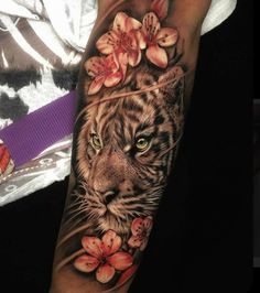 a woman's arm with a tiger and flowers on it