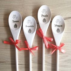 four white spoons with red polka dots tied to them and the names of each spoon