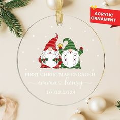 an ornament with two snowmen on it and the words first christmas engaged