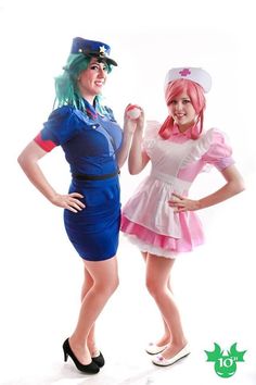 two women dressed up in costumes posing for the camera with one holding her hand out