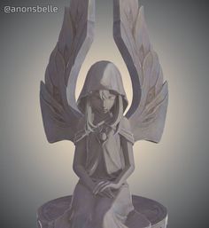 a statue of an angel sitting on top of a table