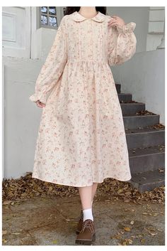 Get ready to fall in love with our Cotton Cottagecore Floral Dress, perfect for your fall and winter wardrobe. Made with cozy cotton fabric, this dress embodies the charming cottagecore aesthetic and features a beautiful floral pattern, peter pan collar and long flared sleeves. Stay stylish and comfortable all season long with this must-have cottagecore dress. Fall Cottagecore Dress With Doll Collar, Spring Casual Long Sleeve Prairie Dress, Spring Cottagecore Prairie Dress With Long Sleeves, Spring Long Sleeve Cottagecore Prairie Dress, Spring Long Sleeve Prairie Dress In Cottagecore Style, Cottagecore Dress For Daywear In Fall, Cottagecore Prairie Dress With Floral Print For Daywear, Cottagecore Long Sleeve Prairie Dress For Fall, Cotton Prairie Dress For Fall Daywear