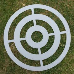 an image of a white target in the grass with it's center circle cut out