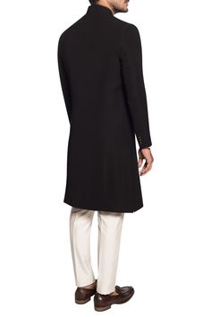 Adorned with regal dori and zardozi hand embroidered motif on the pocket, this classic black sherwani exudes timeless and effortless glamour. Paired with an off-white cotton silk kurta and matching trouser.
comes with kurta
comes with trouser
zardozi embroidery
dori embroidery - Aza Fashions Classic Fitted Sherwani With Naqshi Detailing, Classic Long Sleeve Sherwani With Naqshi, Traditional Black Kurta For Groom, Traditional Drape Black Kurta For Groom, Black Long Sleeve Sherwani For Groom, Classic Fitted Sherwani For Eid, Elegant Black Traditional Wear For Formal Occasions, Classic Long Sleeve Sherwani For Eid, Luxury Long Sleeve Formal Kurta