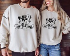 Add a touch of magic to your Valentine's Day with our Personalized Mickey and Minnie Valentine Sweatshirt. Celebrate love and togetherness with our Couples Sweatshirt, or make it a truly special occasion with our Personalized Disneyland Valentine Sweater. The Personalized Initial Sweatshirt is a perfect way to showcase your unique style. Embrace the season of love with these delightful sweatshirts! Ideal for any situation, a unisex heavy blend crewneck sweatshirt is pure comfort. These garments Initial Sweatshirt, Valentine Sweater, Valentine Sweatshirt, Season Of Love, Couples Sweatshirts, Celebrate Love, Sweat Shirts, Mickey And Minnie, Personalized Initials