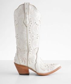 a pair of white cowboy boots sitting on top of a table