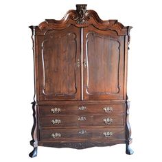 an old wooden armoire with two doors and drawers on it's sides, against a white background