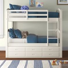 a white bunk bed with blue sheets and pillows on it in a child's room