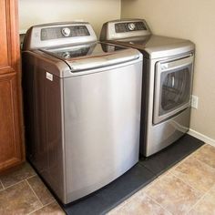 a washer and dryer in a laundry room next to each other on the floor