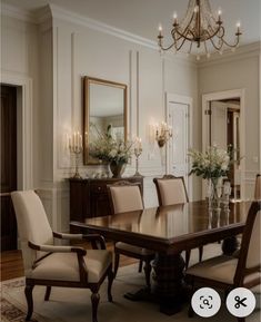 a dining room table with chairs and chandelier in the background, along with an area rug on the floor