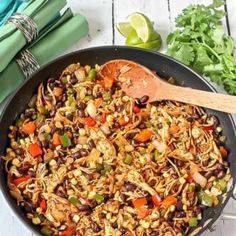 a skillet filled with rice, beans and vegetables