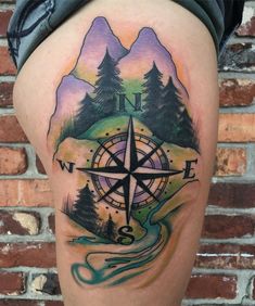 a person with a compass tattoo on their thigh