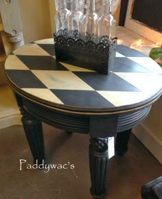 a black and white checkered table with wine glasses on it