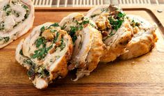 two pieces of bread with meat and herbs on it sitting on a cutting board next to a knife