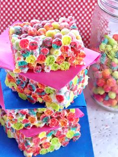 there are many colorful treats stacked on top of each other