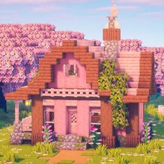 a pink house in the middle of a field with trees and flowers on it's sides