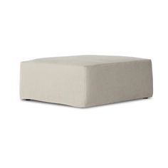 a white ottoman sitting on top of a white floor