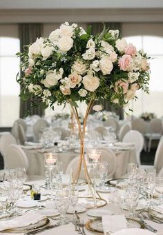 there is a vase with flowers on top of the table at this wedding reception in an elegant setting