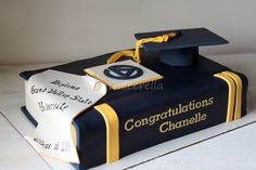 a graduation cake that is shaped like a book