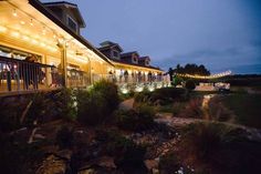 an outside view of a house with lights on it