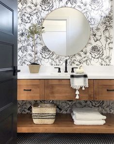 a bathroom with a sink, mirror and towel rack on the counter next to it