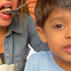 a woman feeding a child food from a bowl